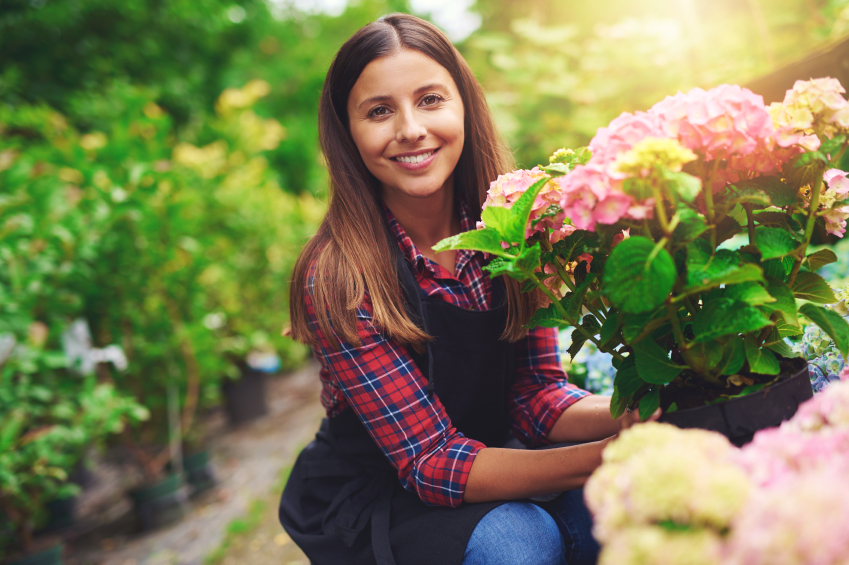 beautiful woman carrying a bouqet a flower pot